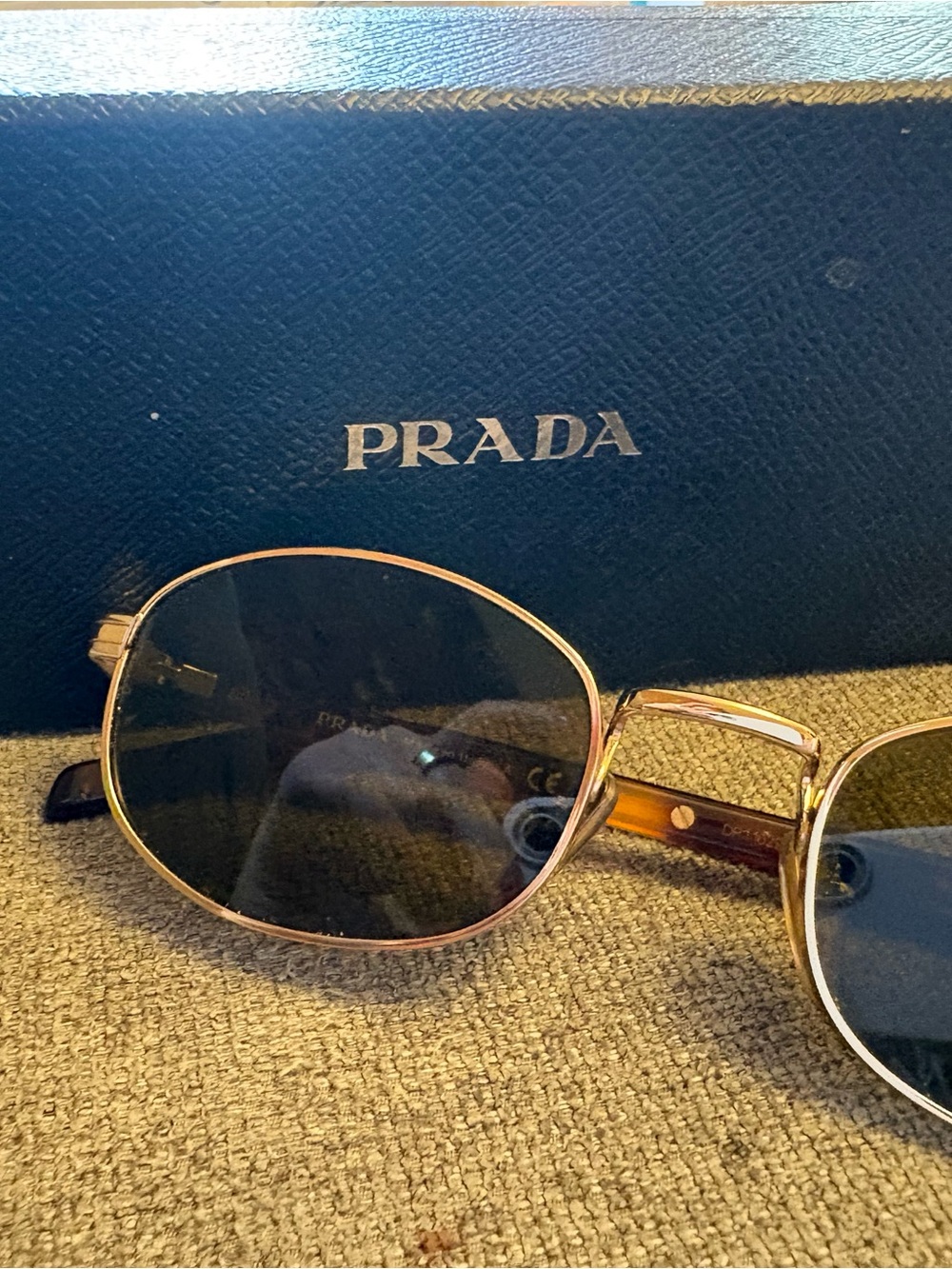 Prada Women’s PR B53 Gold Frame Oval Sunglasses with Brown Lenses